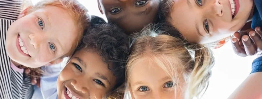 A group of children with blue eyes and brown hair.