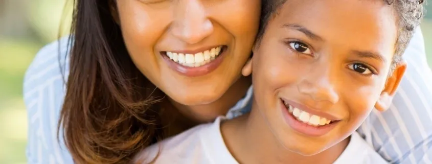 A woman and child smiling for the camera.