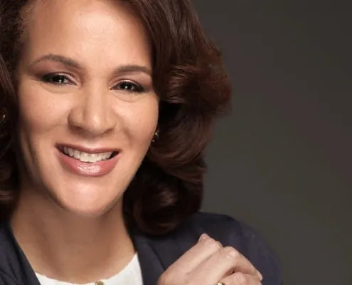 A woman with brown hair and a smile.